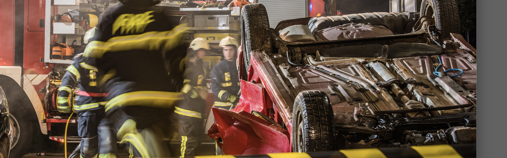 Firefighters and paramedics attend car after a rollover accident.