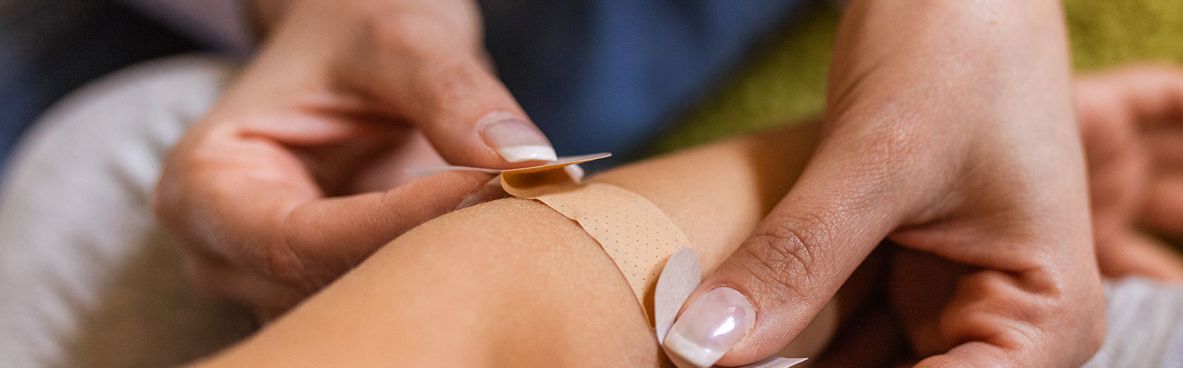 image of a bandaid being applied to an arm